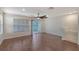 Bright living room featuring hardwood floors, a sliding glass door, a window and modern ceiling fan at 8922 White Sage Loop # 3001, Lakewood Ranch, FL 34202