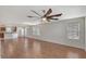 Open-concept living room featuring hardwood floors, multiple windows and a modern ceiling fan at 8922 White Sage Loop # 3001, Lakewood Ranch, FL 34202