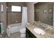 Bathroom with tub, granite vanity, and neutral tile flooring at 7317 Skybird Rd # 7317, Bradenton, FL 34209