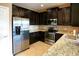 Modern kitchen featuring stainless steel appliances and granite counters at 7317 Skybird Rd # 7317, Bradenton, FL 34209