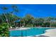 Community pool with lounge chairs and palm trees at 7317 Skybird Rd # 7317, Bradenton, FL 34209