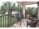 Relaxing screened balcony with outdoor seating and lush tropical views at 7317 Skybird Rd # 7317, Bradenton, FL 34209