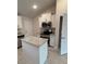 Bright kitchen with an island, white cabinets, and granite countertops at 2665 Ensenada Ln, North Port, FL 34286