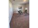 Home office with carpeted floor and glass-top desk at 2665 Ensenada Ln, North Port, FL 34286