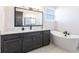 Bathroom with freestanding tub and modern vanity at 5061 Collingswood Blvd, Port Charlotte, FL 33948