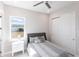 Well-lit bedroom featuring gray bedding and white nightstand at 5061 Collingswood Blvd, Port Charlotte, FL 33948
