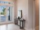 Bright entryway with console table and view of backyard at 5061 Collingswood Blvd, Port Charlotte, FL 33948