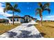 Two-story home with paver driveway and palm trees at 5061 Collingswood Blvd, Port Charlotte, FL 33948