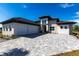 Modern two-car garage home with paver driveway at 5061 Collingswood Blvd, Port Charlotte, FL 33948