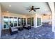 Covered lanai with outdoor kitchen, seating area, and water views at 5061 Collingswood Blvd, Port Charlotte, FL 33948