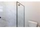 Clean shower with marble tile and frameless glass enclosure at 5061 Collingswood Blvd, Port Charlotte, FL 33948