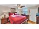 Comfortable bedroom with a ceiling fan, natural light, and wood flooring at 445 Palm Tree Dr, Bradenton, FL 34210
