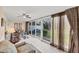 Bright dining area with tile flooring, large windows and modern ceiling fan at 445 Palm Tree Dr, Bradenton, FL 34210