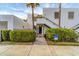 Charming condo exterior featuring lush landscaping, designated parking, and convenient accessibility features at 445 Palm Tree Dr, Bradenton, FL 34210