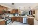 Modern kitchen with stainless steel appliances, granite countertops, and convenient view into living space at 445 Palm Tree Dr, Bradenton, FL 34210
