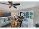 Inviting living room featuring tile floors, ceiling fan and sliding glass doors at 445 Palm Tree Dr, Bradenton, FL 34210