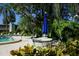 Cozy outdoor seating area with a table, chairs, and umbrella near the pool at 445 Palm Tree Dr, Bradenton, FL 34210
