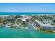 Aerial view of waterfront property with tennis courts and a marina at 5855 Midnight Pass Rd # 416, Sarasota, FL 34242