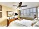 Comfortable bedroom with a queen-size bed, plantation shutters, and ceiling fan at 5855 Midnight Pass Rd # 416, Sarasota, FL 34242