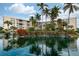 Curved building with pond and landscaping at 5855 Midnight Pass Rd # 416, Sarasota, FL 34242