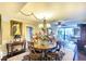 Dining room with a round table, chandelier, and view into living room at 5855 Midnight Pass Rd # 416, Sarasota, FL 34242