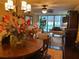 Elegant dining room with a round table and view to the living room at 5855 Midnight Pass Rd # 416, Sarasota, FL 34242