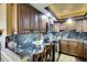 Modern kitchen with granite countertops and wood cabinets at 5855 Midnight Pass Rd # 416, Sarasota, FL 34242