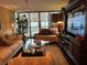 Spacious living room featuring hardwood floors, comfortable seating, and an entertainment center at 5855 Midnight Pass Rd # 416, Sarasota, FL 34242