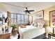 Large main bedroom with a king-size bed, plantation shutters, and ceiling fan at 5855 Midnight Pass Rd # 416, Sarasota, FL 34242
