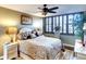 Spacious main bedroom with king-size bed, elegant decor, and ceiling fan at 5855 Midnight Pass Rd # 416, Sarasota, FL 34242