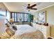 Main bedroom with a king-size bed, plantation shutters, and hardwood floors at 5855 Midnight Pass Rd # 416, Sarasota, FL 34242