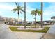Relaxing waterfront view with palm trees and benches at 5855 Midnight Pass Rd # 416, Sarasota, FL 34242
