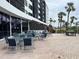 Community patio with tables and chairs, perfect for outdoor relaxation at 5855 Midnight Pass Rd # 416, Sarasota, FL 34242