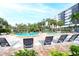 Relaxing pool area with multiple pools, lounge chairs, and palm trees at 5855 Midnight Pass Rd # 416, Sarasota, FL 34242