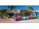 Beach town street scene with colorful vehicles for rent at 5855 Midnight Pass Rd # 416, Sarasota, FL 34242