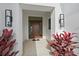 Elegant entryway with modern wood door and lush landscaping at 3739 Caledonia Ln, Sarasota, FL 34240