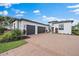 White modern home with three-car garage and paver driveway at 3739 Caledonia Ln, Sarasota, FL 34240