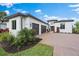 Three-car garage and paver driveway, modern white house at 3739 Caledonia Ln, Sarasota, FL 34240