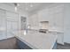 Luxury kitchen with a large island and white shaker cabinets at 3739 Caledonia Ln, Sarasota, FL 34240