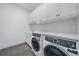 Bright laundry room with white cabinets and modern appliances at 3739 Caledonia Ln, Sarasota, FL 34240