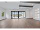 Bright living room with hardwood floors, recessed lighting, and sliding glass doors to the pool area at 3739 Caledonia Ln, Sarasota, FL 34240