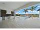 Outdoor kitchen with stainless steel appliances and pool view at 3739 Caledonia Ln, Sarasota, FL 34240