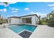 Modern, rectangular pool with a built-in spa and pebble finish at 3739 Caledonia Ln, Sarasota, FL 34240