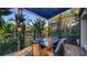 Covered patio with table and chairs, perfect for al fresco dining at 6934 Belgrave Dr, Siesta Key, FL 34242