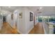 Light and bright hallway with hardwood floors and artwork at 6934 Belgrave Dr, Siesta Key, FL 34242