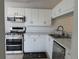 Updated kitchen featuring stainless steel appliances and white cabinetry at 518 Sanderling Cir, Bradenton, FL 34209