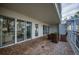 Relaxing balcony with patio furniture and sliding glass doors at 1660 Summerhouse Ln # 102, Sarasota, FL 34242