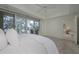 Spacious bedroom with access to balcony and partial water view at 1660 Summerhouse Ln # 102, Sarasota, FL 34242