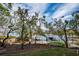 Scenic view of a boat dock with lush landscaping and calm waters at 1660 Summerhouse Ln # 102, Sarasota, FL 34242