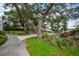 Landscaped walkway leads to a private boat dock with mature oak trees at 1660 Summerhouse Ln # 102, Sarasota, FL 34242